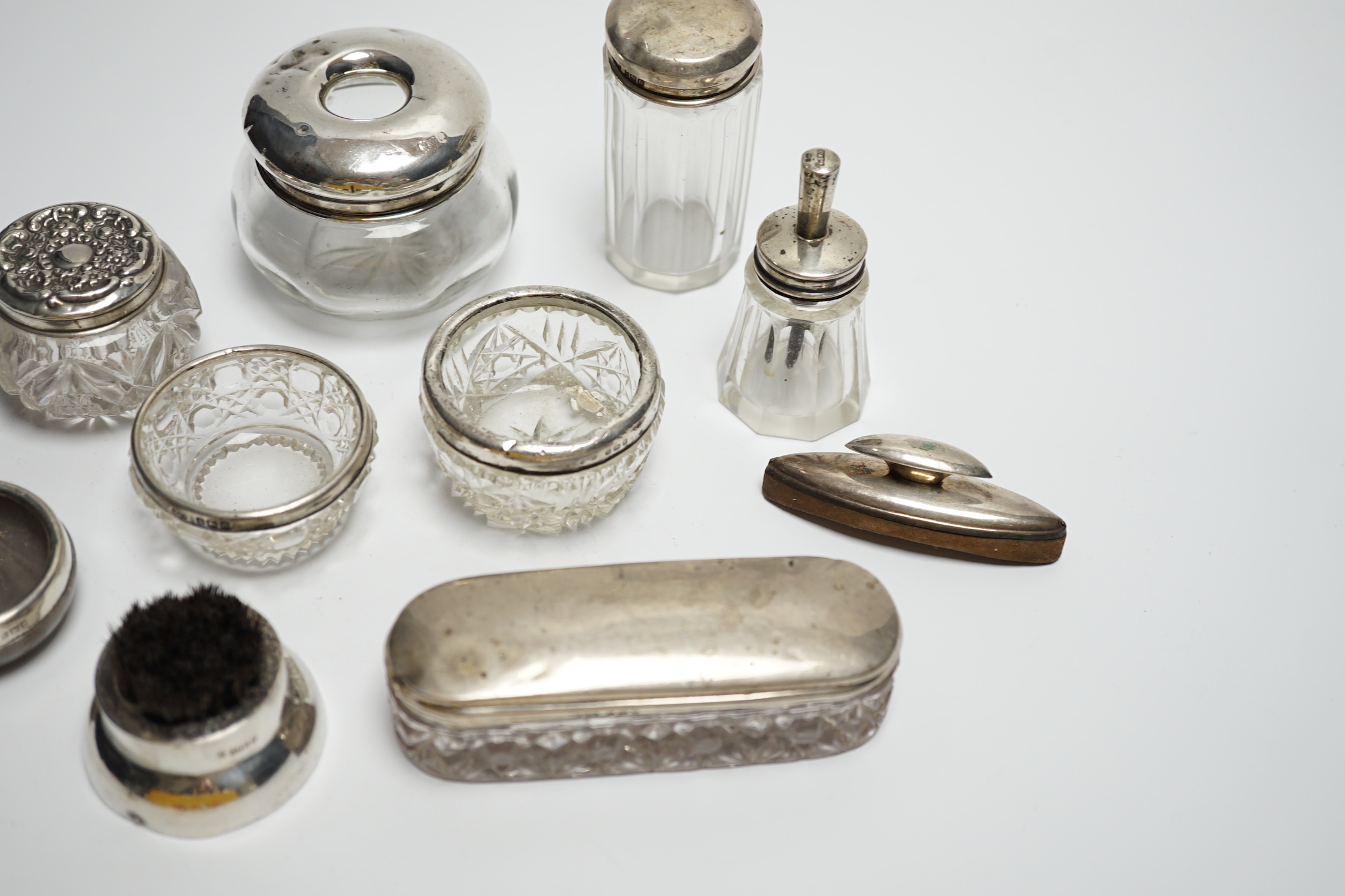 Eight assorted silver topped toilet jars, etc. a silver mounted nail buffer and pen wipe.